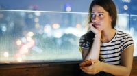 unhappy-young-woman-holding-smartphone-evening-cityscape_53876-30564_compress50.jpg