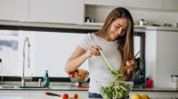 young-woman-making-salad-kitchen_1303-20194.jpg