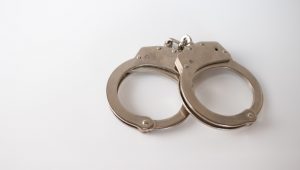 high-angle-shot-metal-handcuffs-isolated_181624-28402
